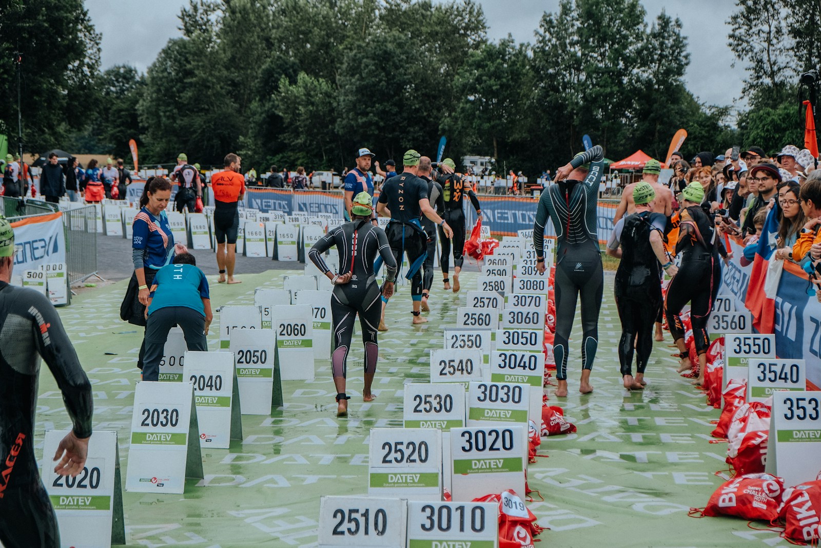 A group of people in wetsuits standing in the water